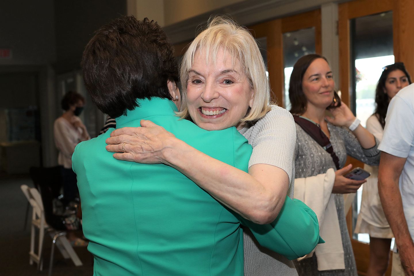 Julie Heldman shares a hug with Billie Jean King.