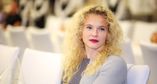 Sitting up and standing out: Katerina Siniakova opted for some striking red lipstick to add to her party look.